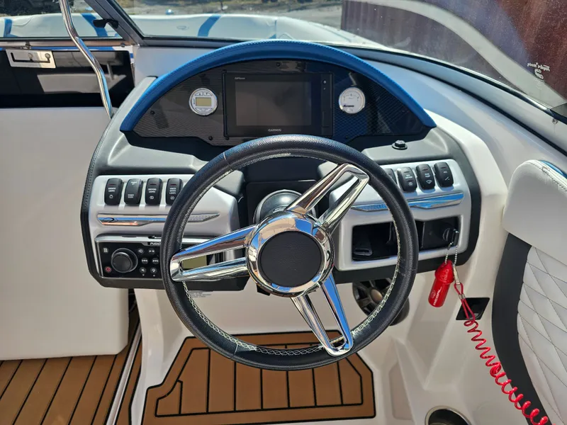 Slide: The Image of Steering console of a 2019 Regal 23 OBX boat. - 24