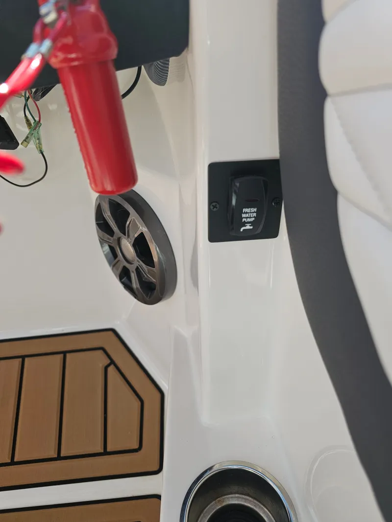 Slide: The Image of Regal 23 OBX 2019 boat console with speaker and water pump switch. - 38