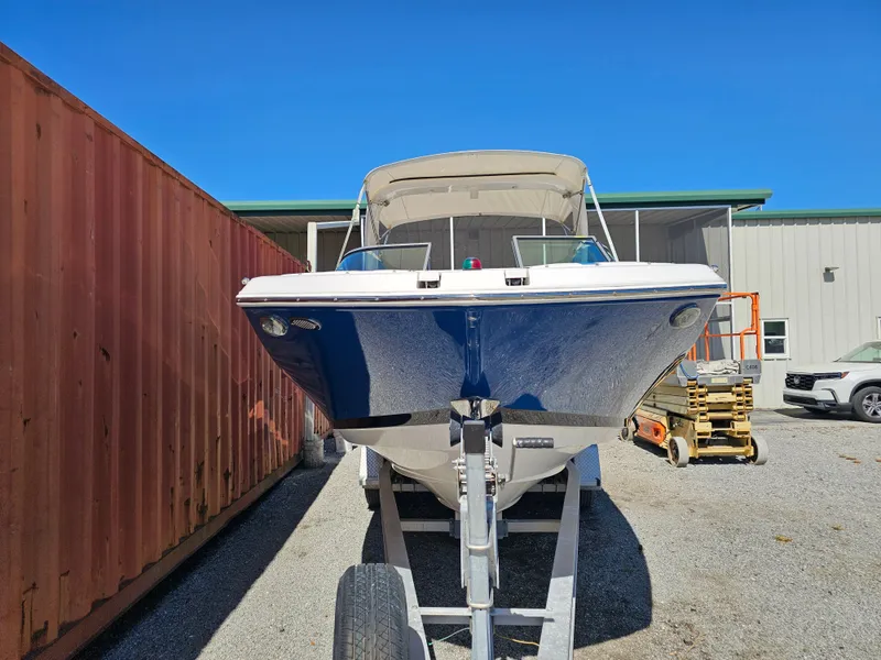 Slide: The Image of 2019 Regal 23 OBX boat on trailer, blue sky. - 49
