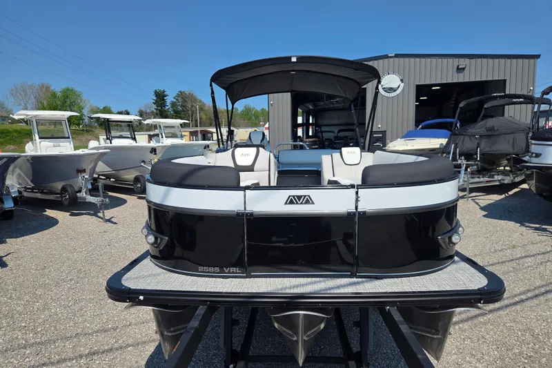 Slide: The Image of 2026 Avalon Platinum Catalina 2585 Versatile Rear Lounger pontoon boat displayed outdoors. - 2
