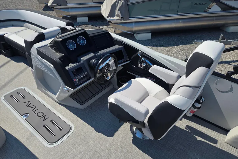 Slide: The Image of 2026 Avalon Platinum Catalina 2585 Versatile Rear Lounger boat interior with captain's chair and dashboard. - 4