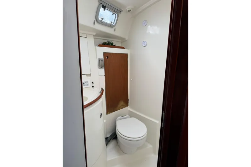 Slide: The Image of Bathroom interior of 1997 Beneteau Oceanis 461 yacht, featuring compact design and wooden accents. - 12