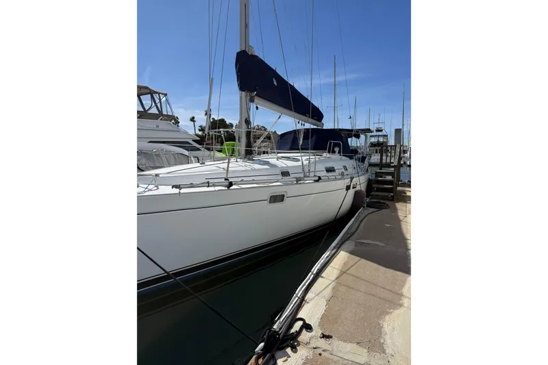Slide: The Image of 1997 Beneteau Oceanis 461 sailboat docked at marina under clear blue sky. - 21
