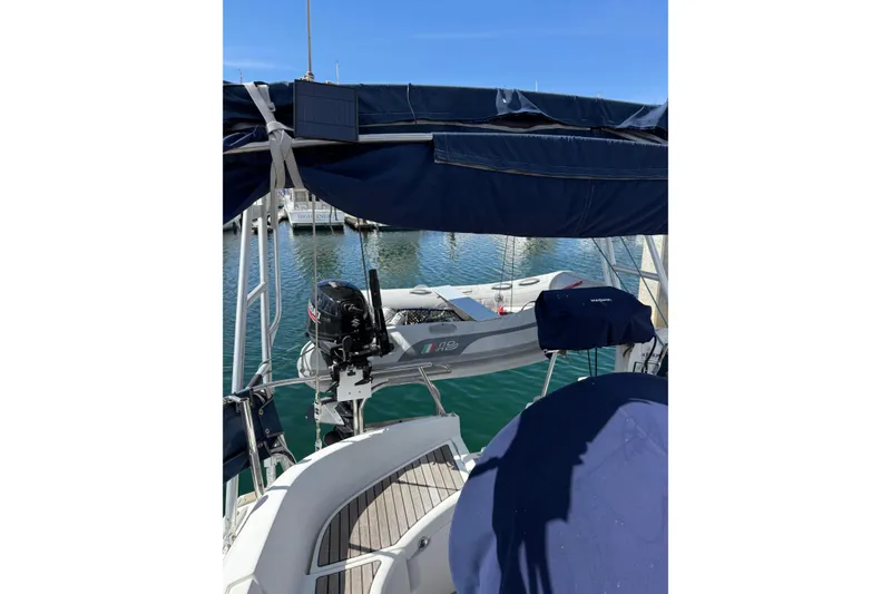 Slide: The Image of 1997 Beneteau Oceanis 461 sailboat with outboard motor and dinghy, docked in marina. - 4