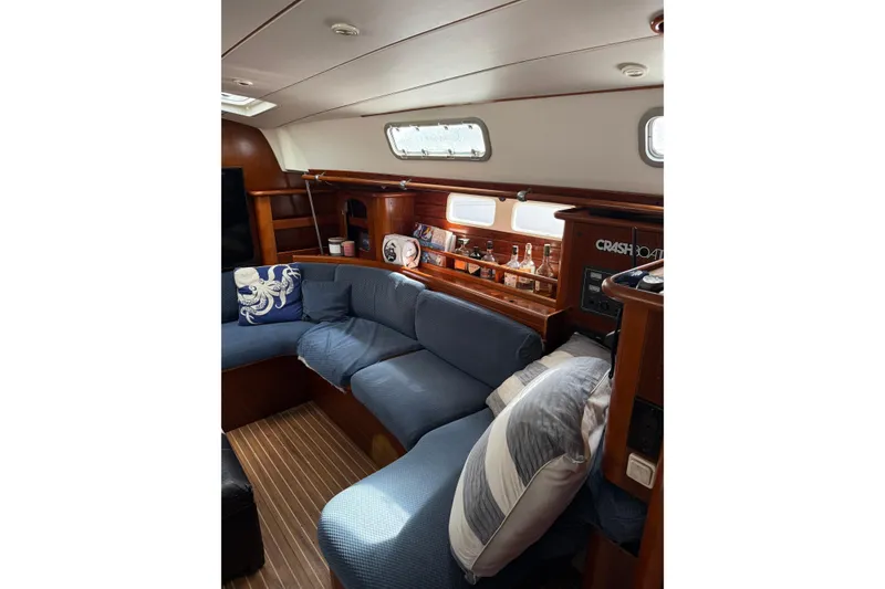 Slide: The Image of Interior of 1997 Beneteau Oceanis 461 sailboat with cozy seating and wooden accents. - 9