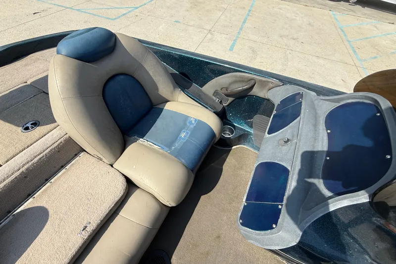 Slide: The Image of 2007 Ranger 188 VS boat interior with beige and blue seating, dashboard view. - 10