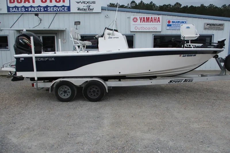 The Image of 2020 Sea Fox 220 Viper boat on trailer outside dealership, featuring Yamaha outboard motor. - 0