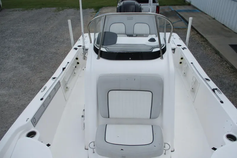 Slide: The Image of 2020 Sea Fox 220 Viper boat interior with seating and console, parked on gravel. - 13