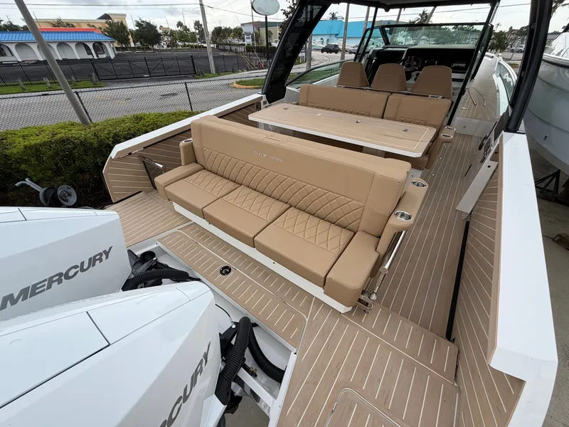 Slide: The Image of The image shows the deck of a 2027 Saxdor 320 GTO with beige seating and two Mercury engines. - 12