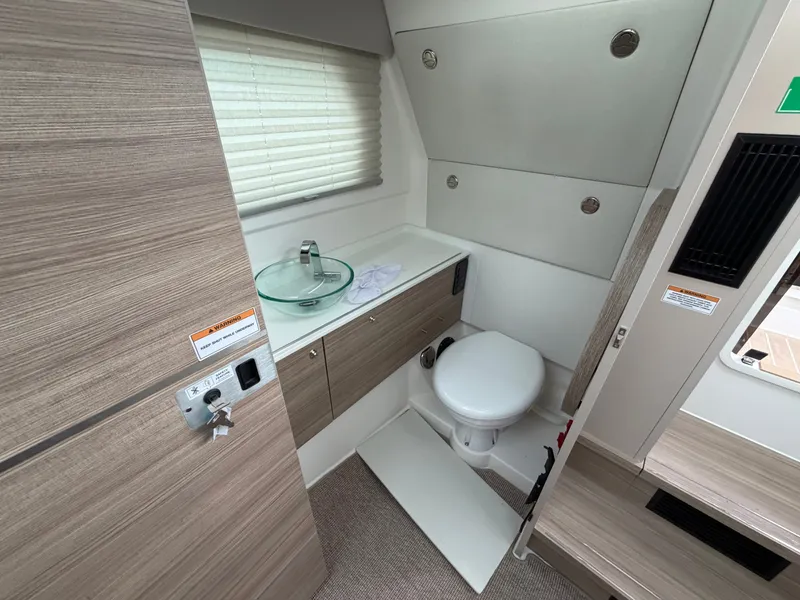 Slide: The Image of The image shows a modern boat bathroom with a sink and toilet. - 29