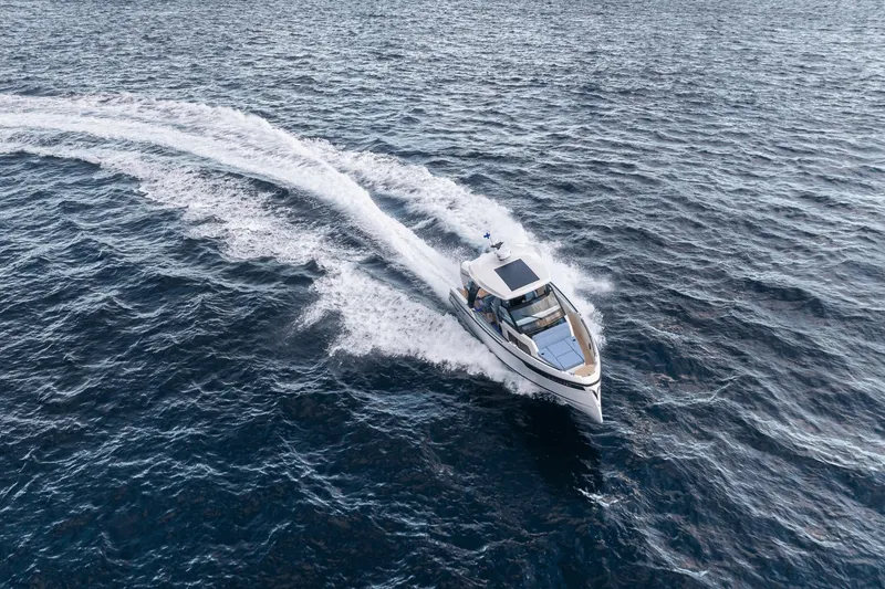 Slide: The Image of A 2027 Saxdor 320 GTO speeds across open water, leaving a trail of white wake. - 0