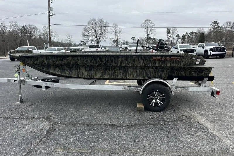 Slide: The Image of 2026 SeaArk 1752 Slayer X boat on trailer in parking lot. - 3