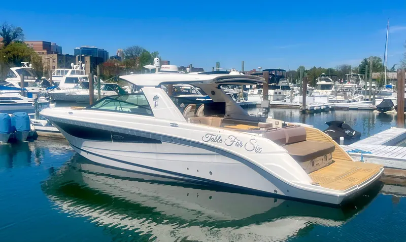 The Image of 2018 Sea Ray SLX 400 yacht docked in a marina under clear blue skies. - 1