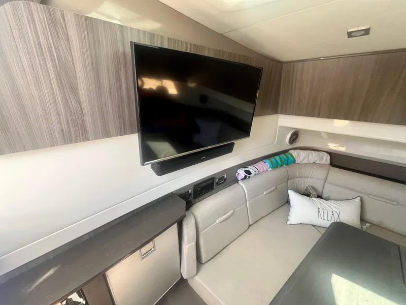 Slide: The Image of Luxurious interior of 2018 Sea Ray SLX 400 yacht with TV and comfortable seating. - 10