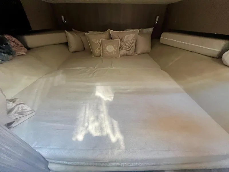 Slide: The Image of Luxurious cabin interior of 2018 Sea Ray SLX 400 with plush bedding and cushions. - 11