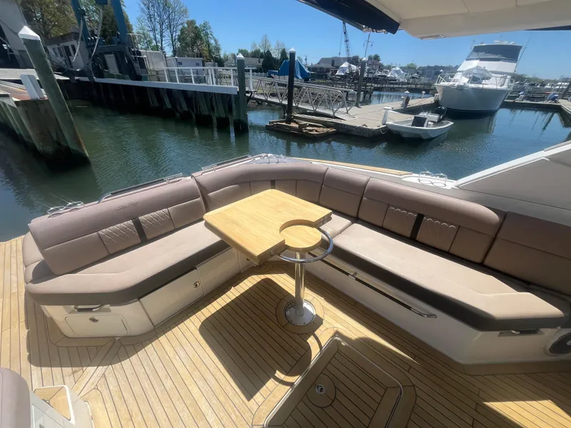 Slide: The Image of 2018 Sea Ray SLX 400 yacht with spacious deck seating and wooden table. - 4