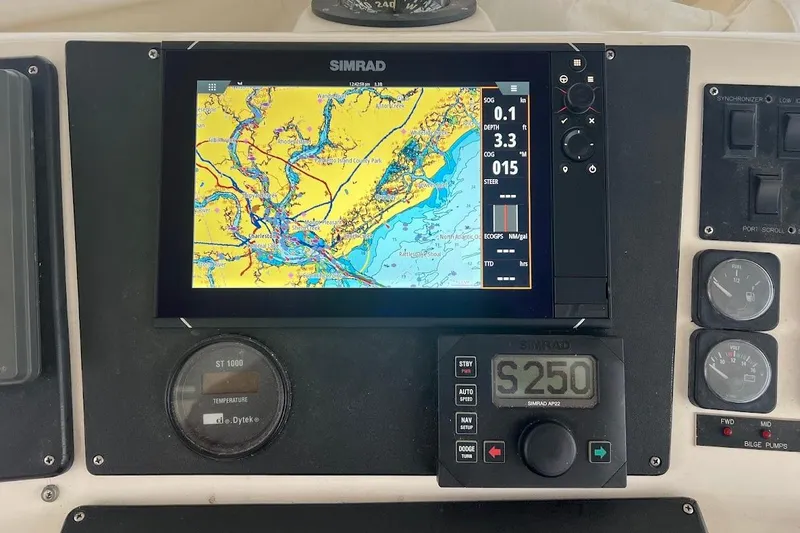 Slide: The Image of Simrad navigation system on 1999 Ocean Yachts 48 Express, displaying nautical chart and controls. - 10