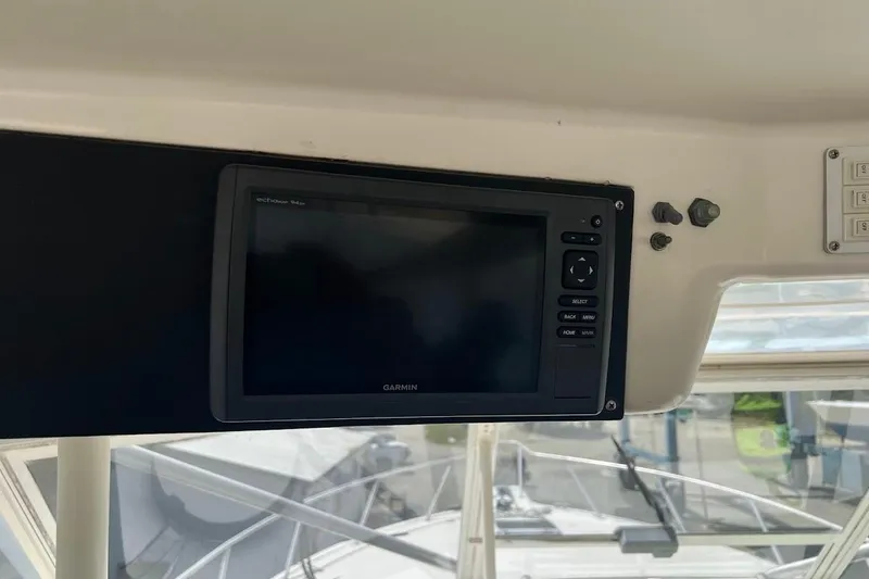 Slide: The Image of Garmin navigation system on 1999 Ocean Yachts 48 Express boat dashboard. - 16