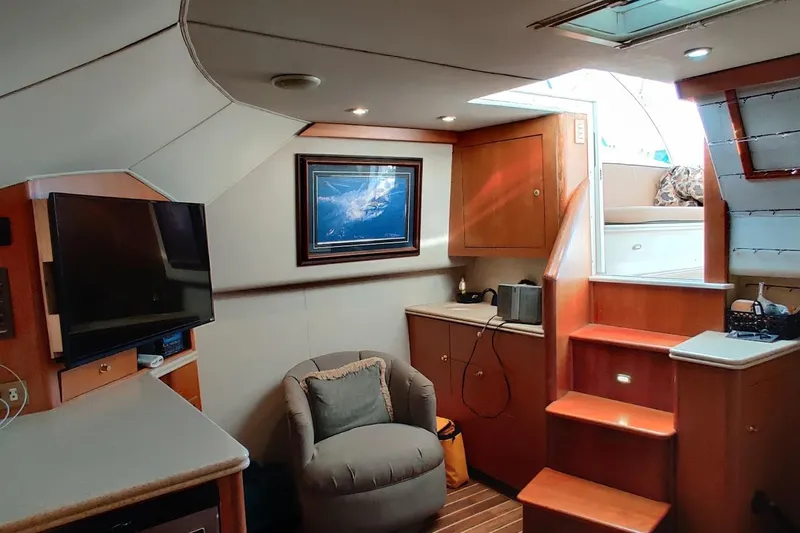 Slide: The Image of Interior of 1999 Ocean Yachts 48 Express, featuring cozy seating and modern amenities. - 20