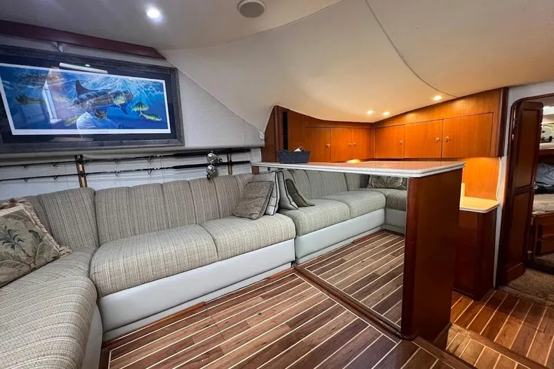 Slide: The Image of Luxurious interior of 1999 Ocean Yachts 48 Express with elegant seating and wooden cabinetry. - 23