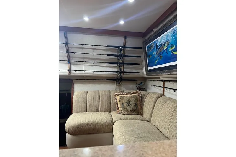 Slide: The Image of Interior of 1999 Ocean Yachts 48 Express with fishing rods and marine artwork. - 24