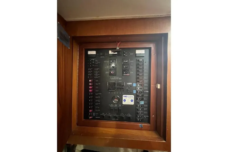 Slide: The Image of Electrical panel of a 1999 Ocean Yachts 48 Express boat, featuring various switches and controls. - 26