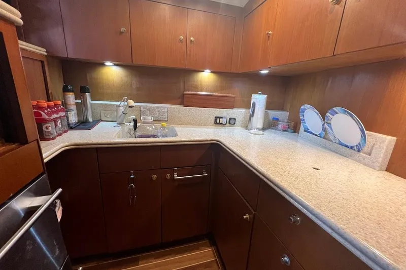 Slide: The Image of 1999 Ocean Yachts 48 Express kitchen with wooden cabinets and modern appliances. - 31