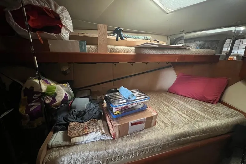 Slide: The Image of 1999 Ocean Yachts 48 Express cabin with bunk beds and storage items. - 37