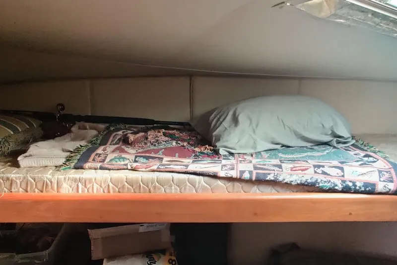 Slide: The Image of Cozy cabin bed in 1999 Ocean Yachts 48 Express, featuring colorful blanket and pillow. - 38