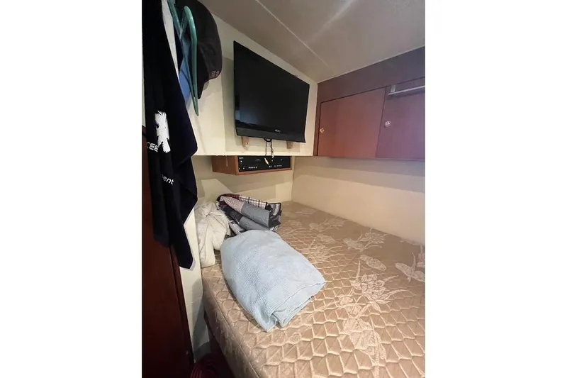 Slide: The Image of Interior of 1999 Ocean Yachts 48 Express with bed and TV. - 44