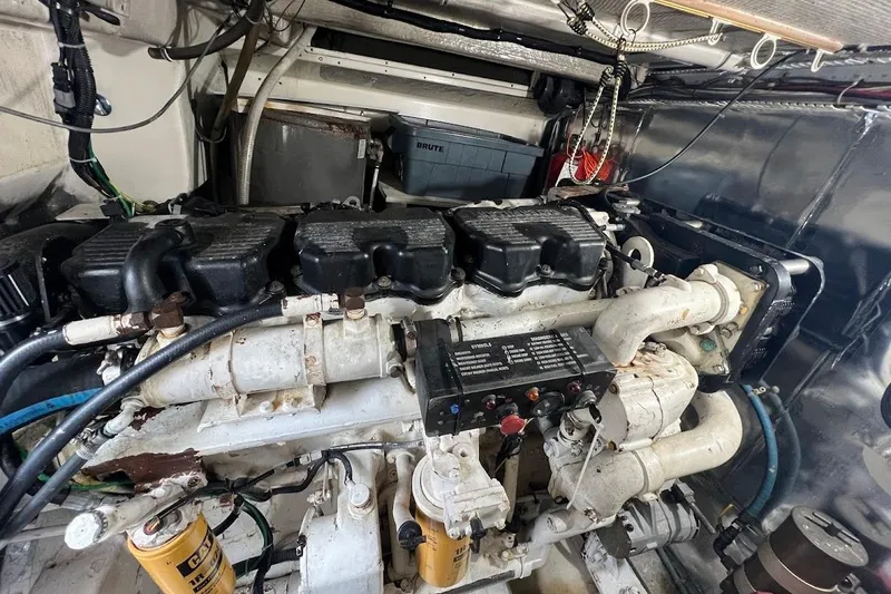 Slide: The Image of Engine room of a 1999 Ocean Yachts 48 Express, showcasing mechanical components. - 49