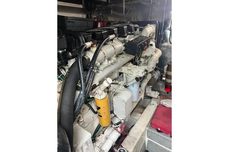 Slide: The Image of Engine room of a 1999 Ocean Yachts 48 Express, showcasing detailed machinery components. - 52