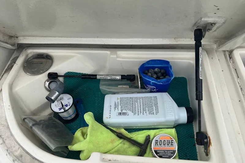 Slide: The Image of Storage compartment on a 1999 Ocean Yachts 48 Express with maintenance supplies and tools. - 55
