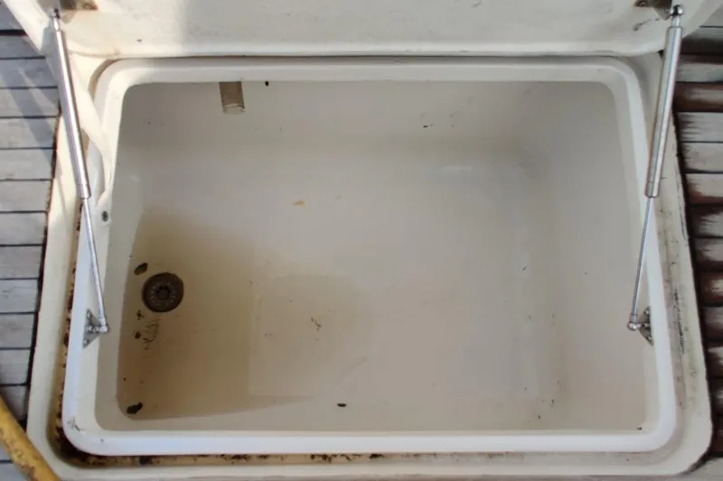 Slide: The Image of Open storage compartment on 1999 Ocean Yachts 48 Express boat deck. - 56