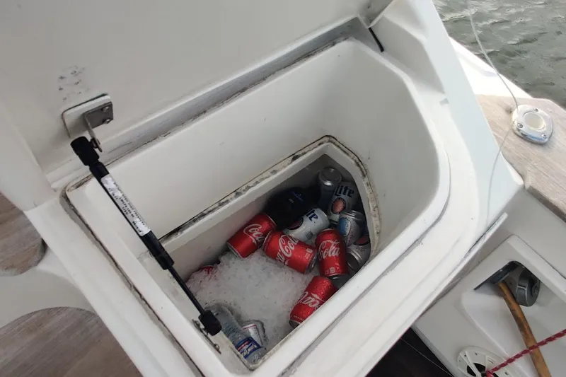 Slide: The Image of Cooler with drinks on 1999 Ocean Yachts 48 Express boat, filled with ice and soda cans. - 58