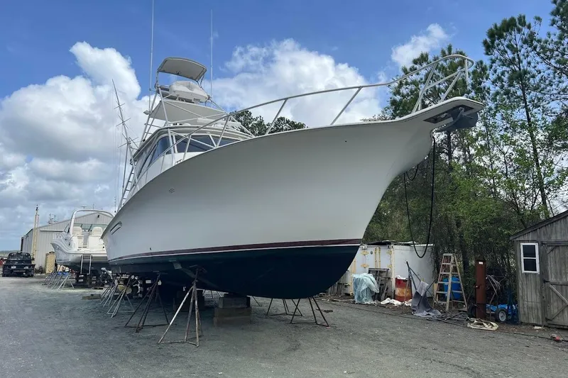 Slide: The Image of 1999 Ocean Yachts 48 Express boat on stands, outdoor storage, clear sky background. - 61