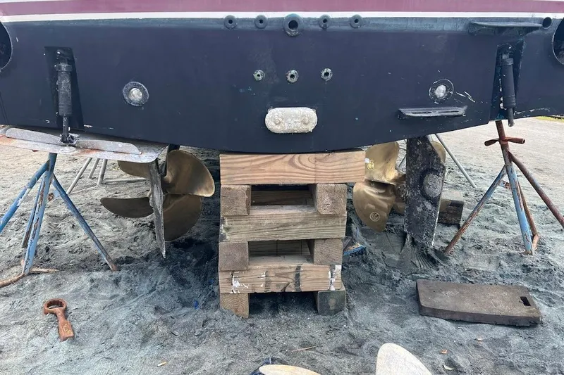 Slide: The Image of 1999 Ocean Yachts 48 Express on blocks, showing propellers and hull details. - 62