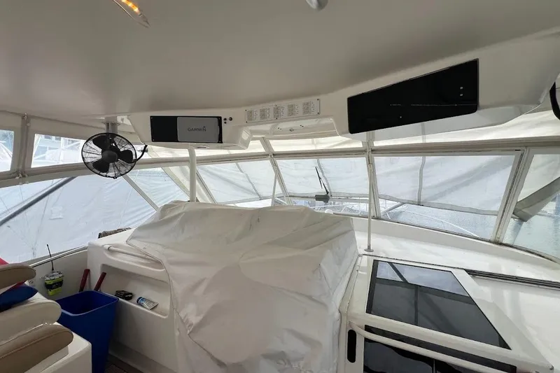 Slide: The Image of Interior view of 1999 Ocean Yachts 48 Express cockpit with covered controls and navigation equipment. - 7