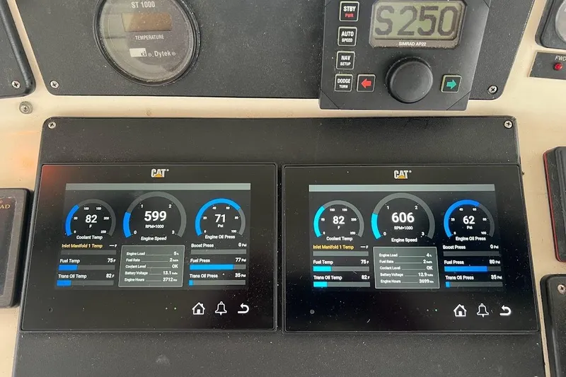 Slide: The Image of Dashboard of a 1999 Ocean Yachts 48 Express showing engine metrics and controls. - 8