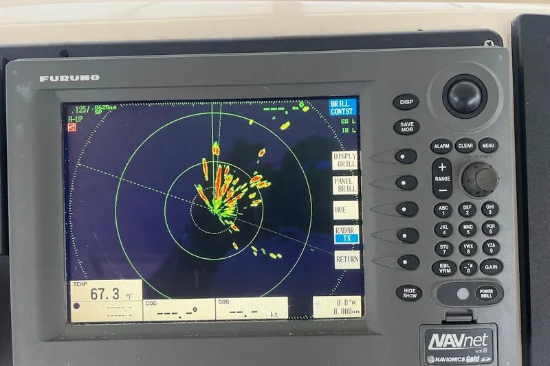 Slide: The Image of Radar display on 1999 Ocean Yachts 48 Express, showing navigation data and controls. - 9