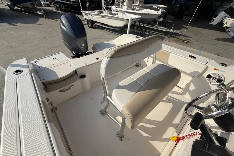 Slide: The Image of 2018 Robalo R200 Center Console boat interior with seating and outboard motor. - 11