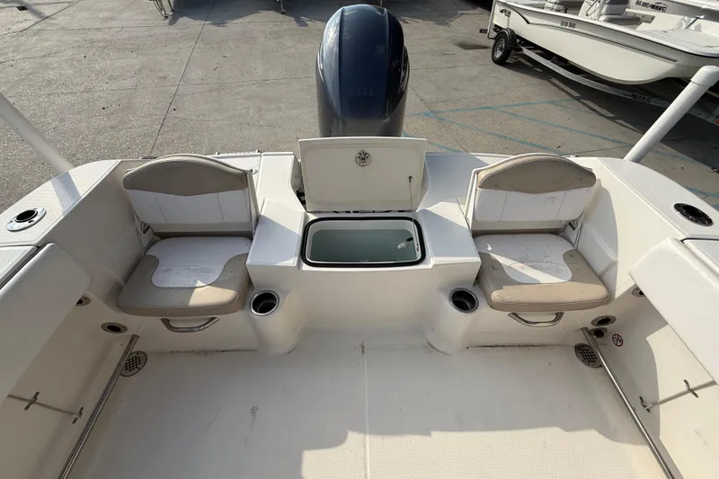 Slide: The Image of 2018 Robalo R200 Center Console boat interior with seating and storage compartments. - 12