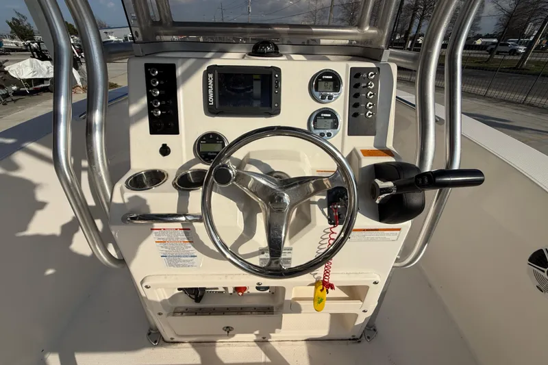 Slide: The Image of 2018 Robalo R200 Center Console boat dashboard with steering wheel and controls. - 13