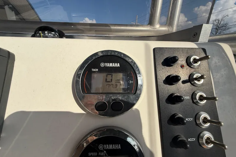 Slide: The Image of Dashboard of 2018 Robalo R200 Center Console with Yamaha tachometer and control switches. - 16