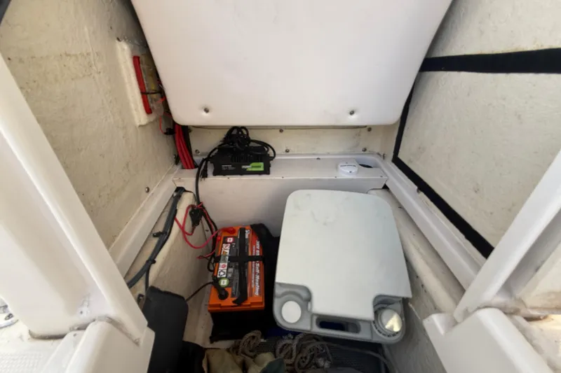 Slide: The Image of 2018 Robalo R200 Center Console boat interior with battery and storage compartment. - 17