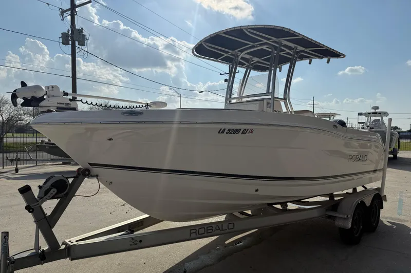 Slide: The Image of 2018 Robalo R200 Center Console boat on trailer, under a clear sky. - 3