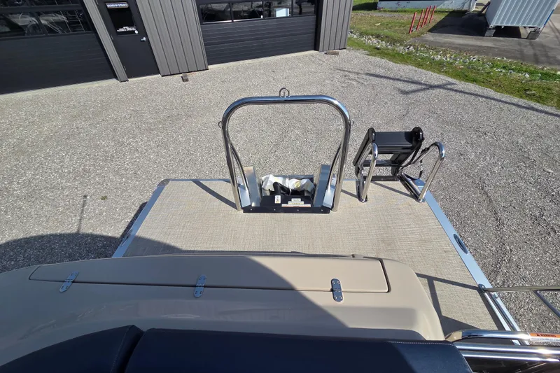 Slide: The Image of 2026 Avalon Platinum Catalina 2585 Windshield Elite boat deck with ladder and railing. - 13