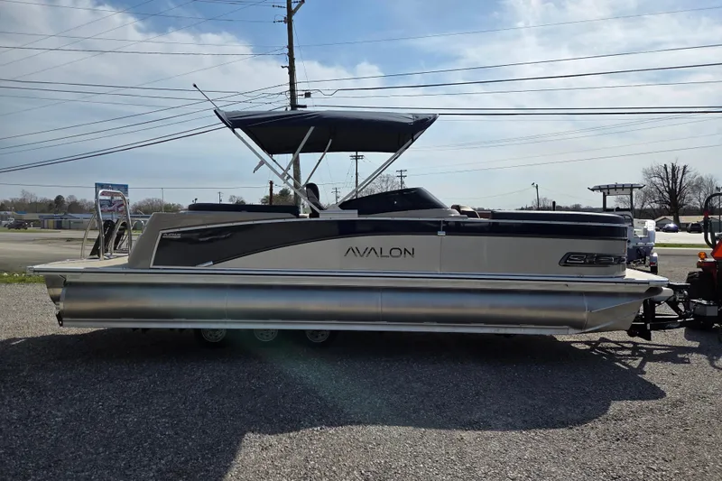Slide: The Image of 2026 Avalon Platinum Catalina 2585 Windshield Elite pontoon boat with canopy, parked outdoors. - 3