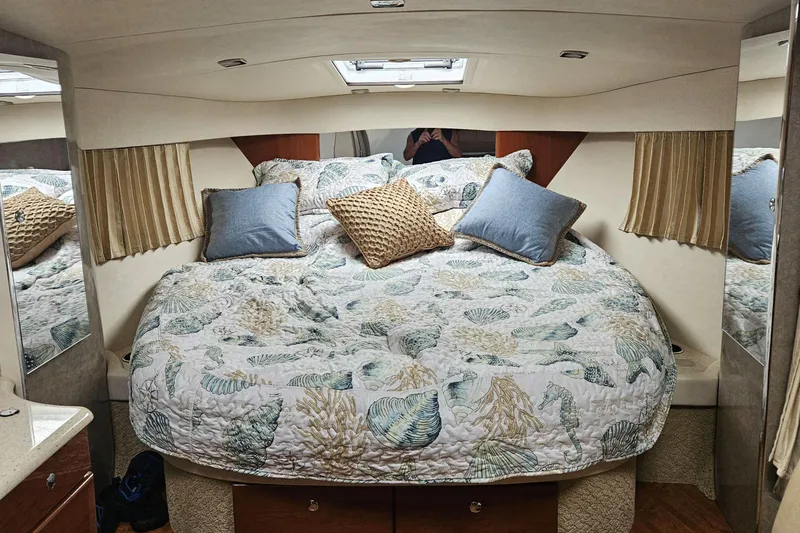 Slide: The Image of Cozy cabin interior of 2010 Formula 34 Performance Cruiser with patterned bedding and pillows. - 10