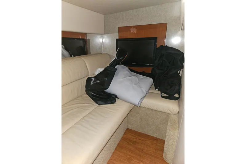 Slide: The Image of Interior of 2010 Formula 34 Performance Cruiser with beige seating and a TV. - 16